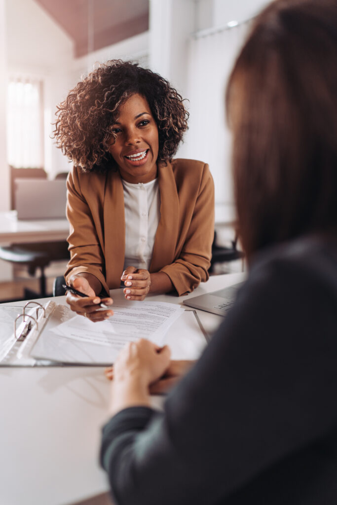 Young woman in the office and talking with client