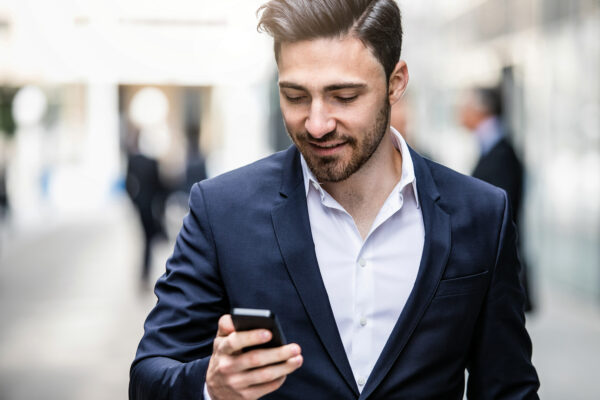 Businessman Looking at the Mobile Phone